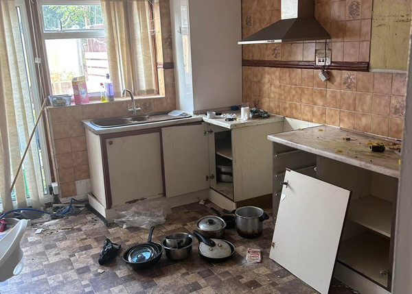 dirty kitchen with unwashed dishes and cluttered countertops showing disorganization and need for cleaning five essential tips for a cleaner kitchen